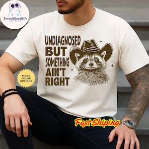 Undiagnosed But Something Aint Right Shirt, Raccoon cowboy Shirt, Mental Health Shirt, Sarcastic Shirt, Funny Sayings Shirt, Trendy Shirt