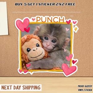May include: A glossy vinyl sticker featuring a baby monkey hugging a stuffed monkey. The sticker has a yellow border with pink hearts and the word "PUNCH". The text "BUY 5 GET 1 STICKER 2X2 FREE" is at the top.