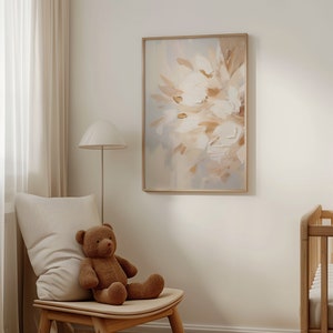 May include: A framed abstract painting with a light blue background and white and beige brushstrokes. The painting is hanging on a white wall in a room with a teddy bear sitting on a wooden chair.