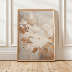 May include: A framed abstract painting featuring a close-up of white flowers with brown and beige accents. The painting has a soft, muted colour palette and a painterly texture.