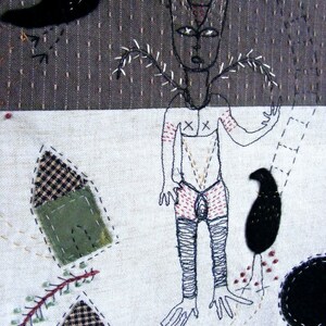 May include: A black and white embroidered artwork depicting a stylized figure with a bird and other abstract shapes. The figure has a long, thin body with a head that resembles a fox or a wolf. The figure is wearing a pair of red and white pants. The bird is black and has a long, thin beak. The artwork is on a white background.