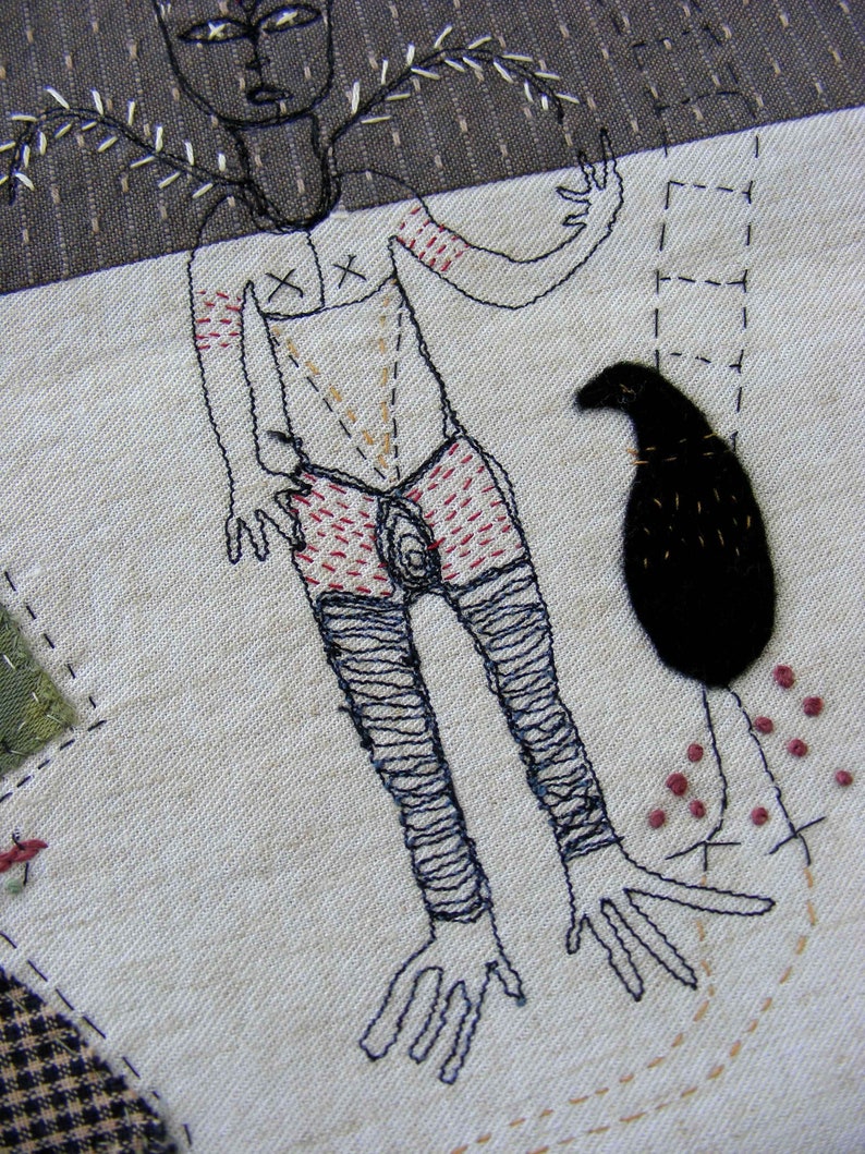 May include: Embroidered artwork depicting a stylized human figure with a bird and a floral design. The figure is outlined in black thread and has red and brown details. The bird is black and the floral design is in shades of brown.