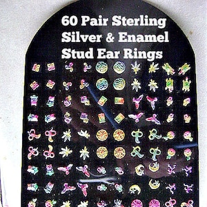 May include: A black display card with 60 pairs of sterling silver and enamel stud ear rings. The earrings are in various shapes and colors, including pink, green, yellow, and blue. The text "60 Pair Sterling Silver & Enamel Stud Ear Rings" is at the top.