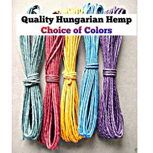 May include: Five bundles of hemp cord in teal, red, yellow, blue, and purple, each tied with a small loop. The text Quality Hungarian Hemp Choice of Colors is overlaid on the image. The cord has a textured, fibrous appearance.