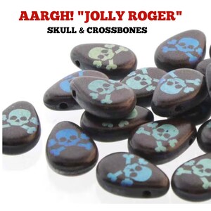 May include: A collection of black teardrop-shaped beads with a skull and crossbones design in blue and green. The beads have a hole at the top for stringing.