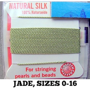 May include: A spool of jade green natural silk thread for stringing pearls and beads. The label reads "NATURAL SILK 100% Naturseide" and "For stringing pearls and beads" with the Griffin logo and "JADE, SIZES 0-16".