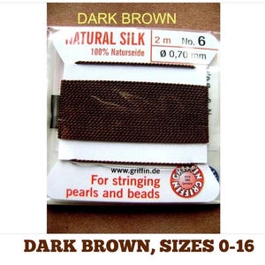 May include: Dark brown natural silk thread for stringing pearls and beads. The thread is 2 meters long and 0.70 millimeters in diameter. The packaging says "Natural Silk 100% Naturseide" and "For stringing pearls and beads".