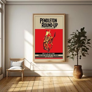 May include: A vintage poster advertising the Pendleton Round-Up rodeo in Pendleton, Oregon. The poster features a red background with a cowboy riding a bucking bronco. The text on the poster reads "Pendleton Round-Up", "Pendleton, Oregon", "Sept. 11, 12, 13, 14, 1940", "The Epic Drama of the West", and "Let 'er Buck".