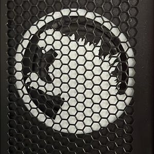 May include: Black metal panel with a honeycomb pattern and a circular design in the center. The design is white and appears to be a stylized dragon or creature. The top of the panel has a red sticker with the text "NEW WAYS TO PLAY! TRACK YOUR PROGRESS!" and the "INSIDER CONNECTED" logo.