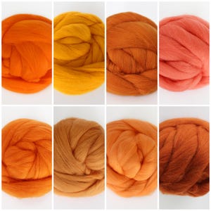 May include: Eight balls of wool yarn in various shades of orange, yellow, and brown. The yarn is arranged in two rows of four balls.