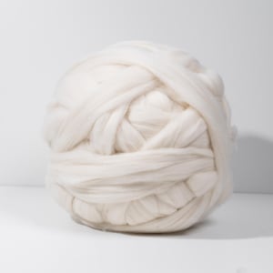 May include: A large ball of white yarn, perfect for knitting or crocheting.