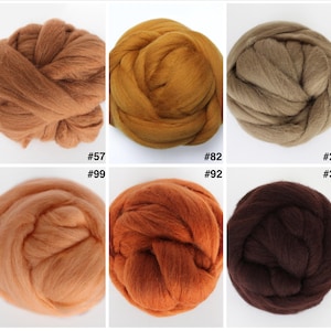 May include: A collection of ten different shades of wool roving, ranging from light beige to deep brown. Each color is displayed in a round, fluffy bundle with a corresponding number label. Ideal for fiber art and crafts.