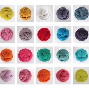Puede incluir: Una colección de cuarenta ovillos individuales de lana peinada dispuestos en una cuadrícula, que muestran una paleta diversa de colores que incluye tonos de rojo, azul, verde, amarillo, rosa, morado, naranja, marrón, gris, negro, blanco y crema.