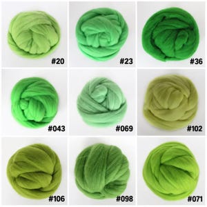 May include: Nine round bundles of green wool roving arranged in a grid. Each bundle is labeled with a number: #20, #23, #36, #043, #069, #102, #106, #098, and #071. The wool displays various shades of green, ranging from light lime to deep forest.