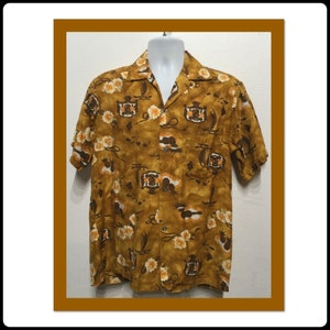 May include: A brown short-sleeved shirt with a tropical print featuring palm trees, boats, and flowers. The shirt has a button-up front and a collared neckline.