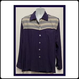 May include: A long-sleeved button-down shirt with a navy blue body and a striped beige and gray yoke.