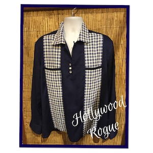 May include: A navy blue long-sleeved shirt with a white and blue checked pattern on the front and back. The shirt has a collar and a button-up front.