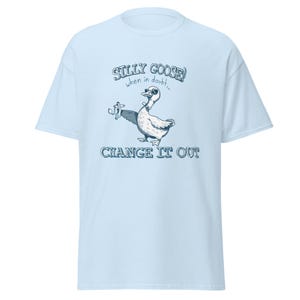 May include: Light blue t-shirt with a cartoon goose wearing sunglasses and the text "Silly Goose! When in doubt... Change it out".
