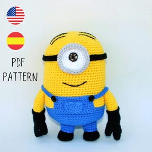 May include: A crocheted Minion toy in yellow, blue, and black, featuring a single eye and overalls. The text "PDF PATTERN" is displayed. The Minion has a smiling face and is a character from the Despicable Me films.