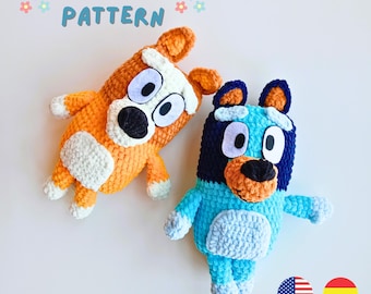 May include: Two crocheted stuffed dog toys. One is orange and white with black eyes and nose. The other is blue, black, and white with brown eyes and nose. The toys are on a white background with the text "PDF PATTERN" above them.