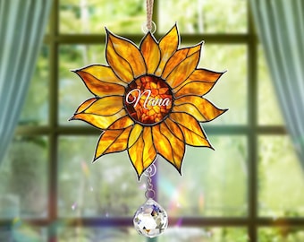 May include: A stained glass sunflower suncatcher with the word "Nana" in the center. The suncatcher has a crystal prism hanging from the bottom.