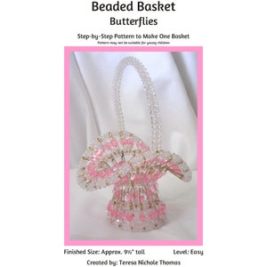 May include: A beaded basket with a pink and clear design. The basket is 9 1/2 inches tall and is made with beads and safety pins. The basket is shaped like a butterfly and has a handle. The basket is easy to make and is a great project for beginners.