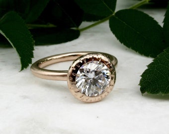 Open bezel moissanite engagement ring