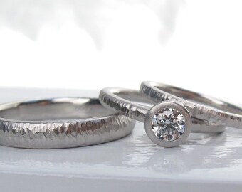 Platinum wedding ring set with low profile diamond bezel set engagement ring with hammered wedding bands