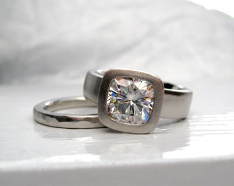 Wide band cushion cut moissanite engagement ring with matching hammered wedding band