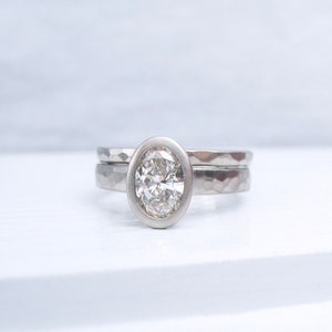 One carat oval diamond engagement ring and hammered wedding band