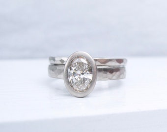 One carat oval diamond engagement ring and hammered wedding band