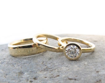 Classic gold and diamond bezel set engagement with gold wedding bands