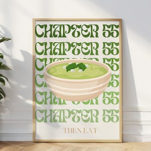 May include: A framed art print featuring a bowl of green food, possibly guacamole, with white accents. The words "CHAPTER 55" are repeated in green, with "THEN EAT" at the bottom. The print has a beige background and a wooden frame.