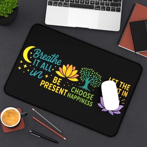 May include: Black rectangular mousepad with the text "Breathe it all in, be present, choose happiness." The design includes a yellow crescent moon, stars, a lotus flower, and a tree. A white mouse and a laptop are visible.