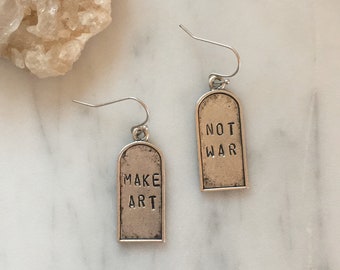 Make Art Not War earrings / silver version