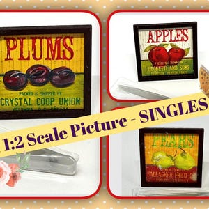 May include: Miniature framed pictures of fruit, including plums, apples, and pears. The plum picture reads "PLUMS" and "Crystal Coop Union." The apple picture reads "APPLES" and "Leonetti and Sons." The pear picture reads "PEARS" and "Gallagher Fruit."