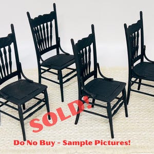 May include: Four miniature black chairs with detailed backs and seats. The chairs have a classic design, with curved legs and decorative elements. The image includes the text "SOLD" and "Do No Buy - Sample Pictures!"
