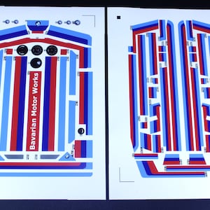Pode incluir: Duas folhas de papel branco com decalques azuis, vermelhos e brancos para um carro. Os decalques incluem as palavras "Bavarian Motor Works".
