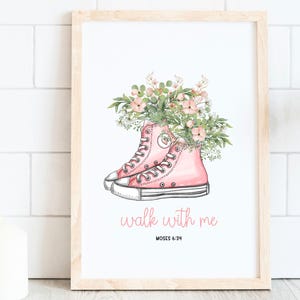 May include: A framed print featuring pink high-top sneakers filled with flowers. The words "walk with me" are written in cursive below the shoes, with "Moses 6:34" underneath. The text "2026 Youth Theme" is at the top.
