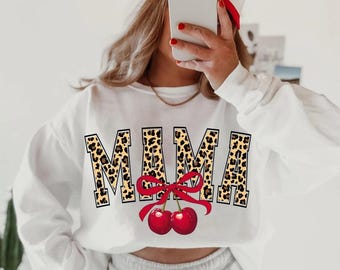 May include: White sweatshirt with the word "MAMA" printed in leopard print with a red bow and two red cherries underneath.