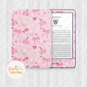 May include: A pink Kindle e-reader with a cherry and bow pattern on the cover. The screen displays the text "Chapter 1" and "Flame of Tar Valon".