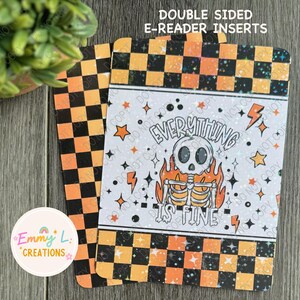 May include: Double-sided e-reader insert with a black and orange checkered pattern on one side and a white background with a skeleton in flames and the text "Everything is fine" on the other side.