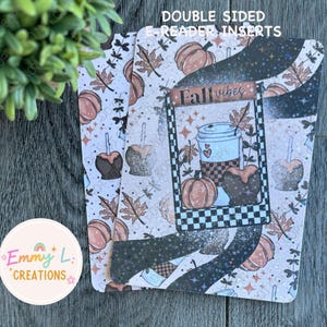 May include: Double-sided e-reader inserts with a fall theme. The inserts feature pumpkins, caramel apples, and fall leaves. The center design has a coffee cup, pumpkin, and the words "Fall vibes" in a black and white checkered frame.