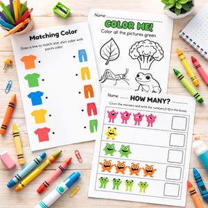 May include: Educational worksheets for children with colorful illustrations and text. The worksheets include activities like matching colors, coloring, and counting. Crayons and pencils surround the worksheets on a wooden surface.