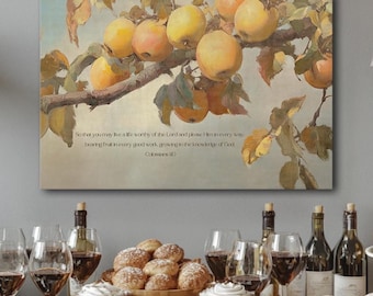 May include: A canvas print featuring a still life of ripe apples on a branch, with text from Colossians 1:10. The image is set above a table with wine glasses, bottles, and pastries, suggesting a gathering or celebration.