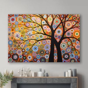May include: Abstract painting of a tree with a colorful background of circles in shades of orange, yellow, blue, green, and purple. The tree is black and has two trunks.