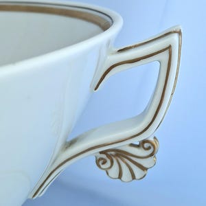 May include: A set of three ceramic mugs with a speckled, matte finish. The mugs are in shades of cream, light gray, and dark gray. Each mug has a simple, minimalist design, perfect for coffee or tea.
