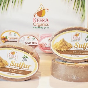 Puede incluir: Cuatro barras de jabón natural, dos son marrones y están etiquetadas con "Sulfur Face and Body Soap" con la marca "KEERA Organics" y el texto "100% Natural". Las otras dos barras están etiquetadas con "Turmeric" y "Goat Milk" con la marca "KEERA Organics" y el texto "100% Natural".