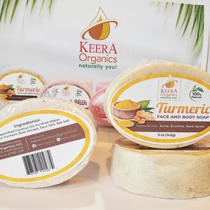 May include: Two bars of turmeric face and body soap, one with the ingredients listed on the back and the other with the product name and description. The soap is a light yellow color and is packaged in clear plastic wrap.