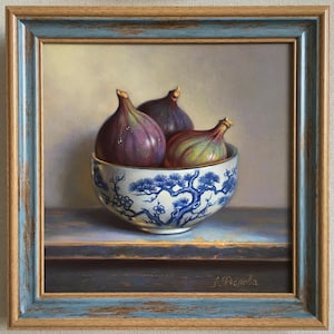 May include: An oil painting in a distressed blue and wood-toned frame depicting three fresh figs inside a white ceramic bowl decorated with blue painted pine tree branches. The artwork features a signature in the bottom right corner.